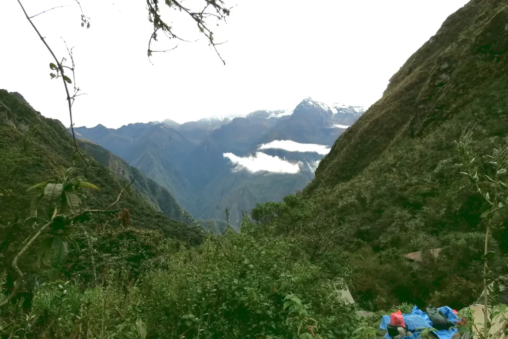 Panoramic view of the green cloud forest valley and snow-capped Andes mountains along the 4-day Inca Trail to Machu Picchu.