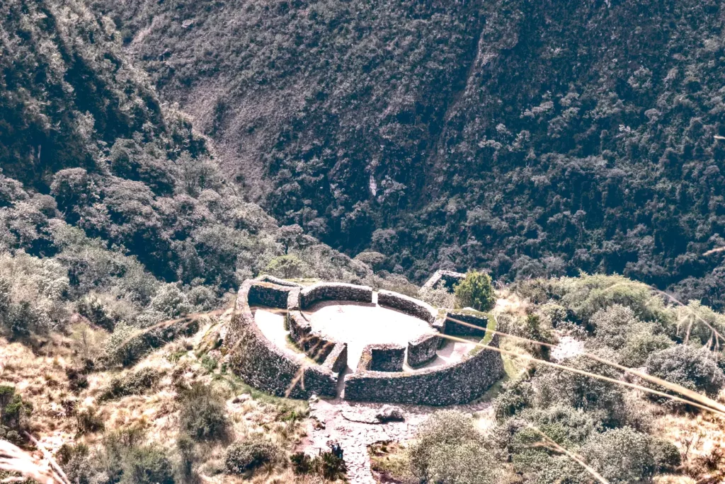 Aerial view of the semi-circular Runkurakay Inca ruins surrounded by mountain vegetation on the 4-day Inca Trail trek.