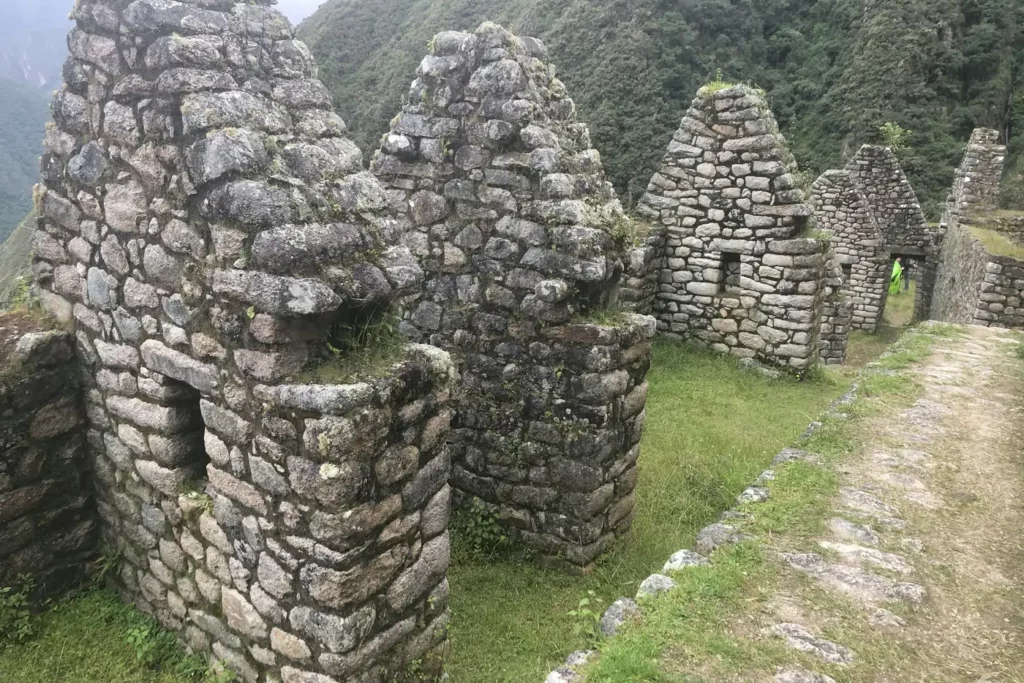 Ancient stone building gables and pathway at Wiñay Wayna ruins along the 2-day short Inca Trail hike.